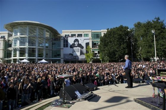 In this Oct. 19, 2011 file photo provided by Apple Inc., Apple CEO Tim Cook speaks to employees at a celebration of Steve Jobs' life, at Apple headquarters in Cupertino, Calif.